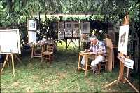 felibre1  Demonstrating woodcuts on a rustic stand at the "Felibree" Fair in 1998, Jumilhac le Grand,  as part of the theme of the fair - 'traditional wood crafts'.